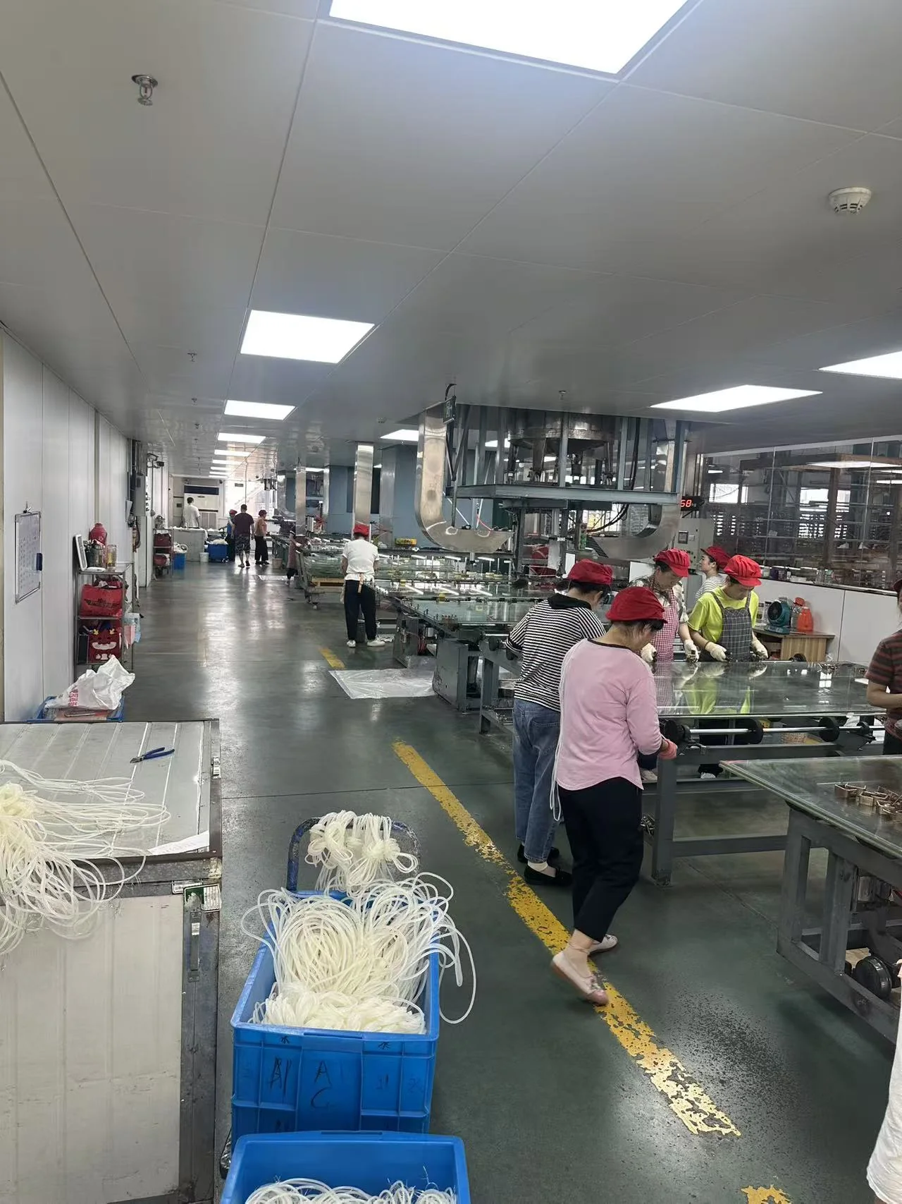 Worker handling acrylic sheets on the finishing line