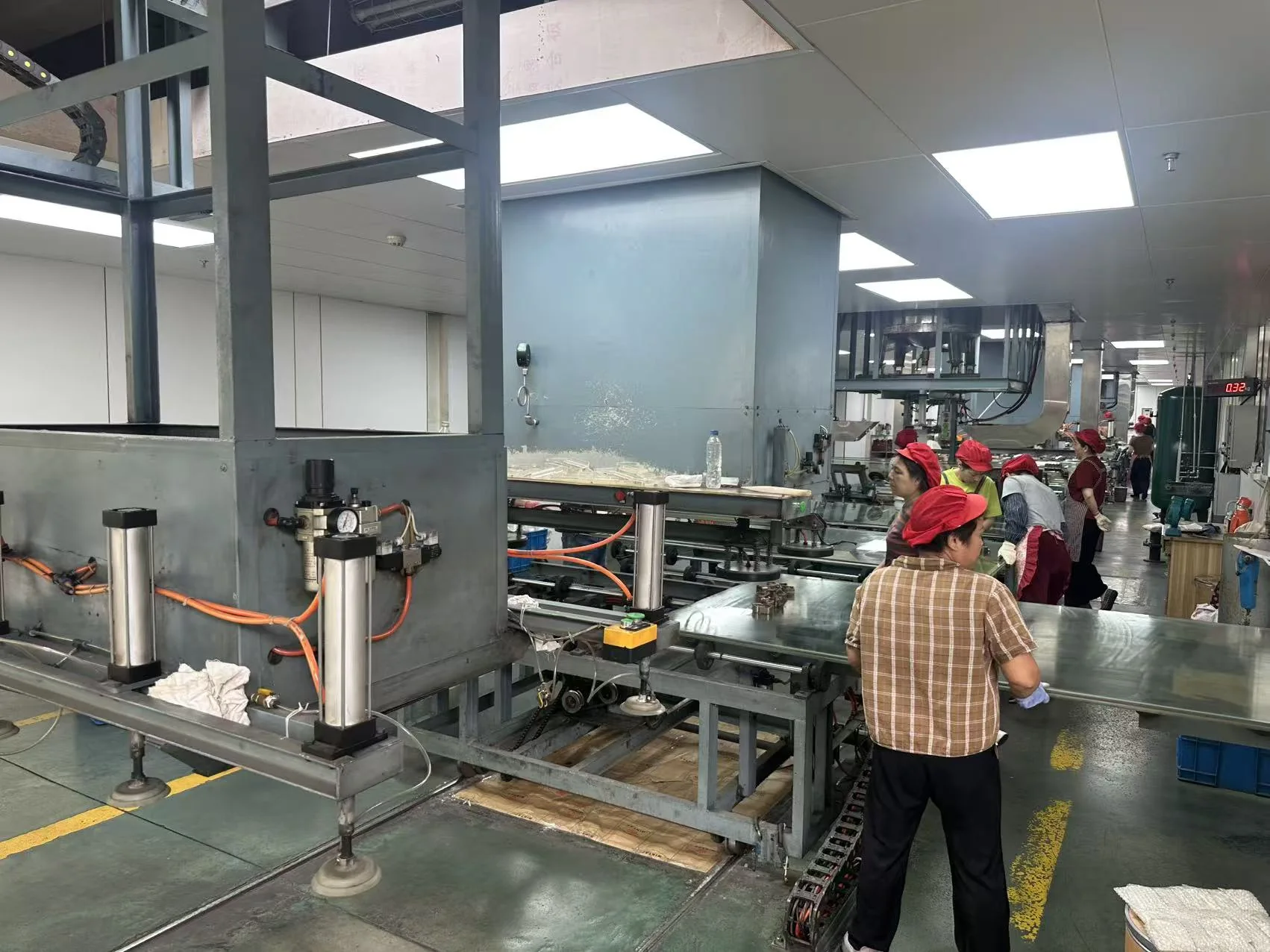 Maiming Acrylic production team working on the sheet finishing line