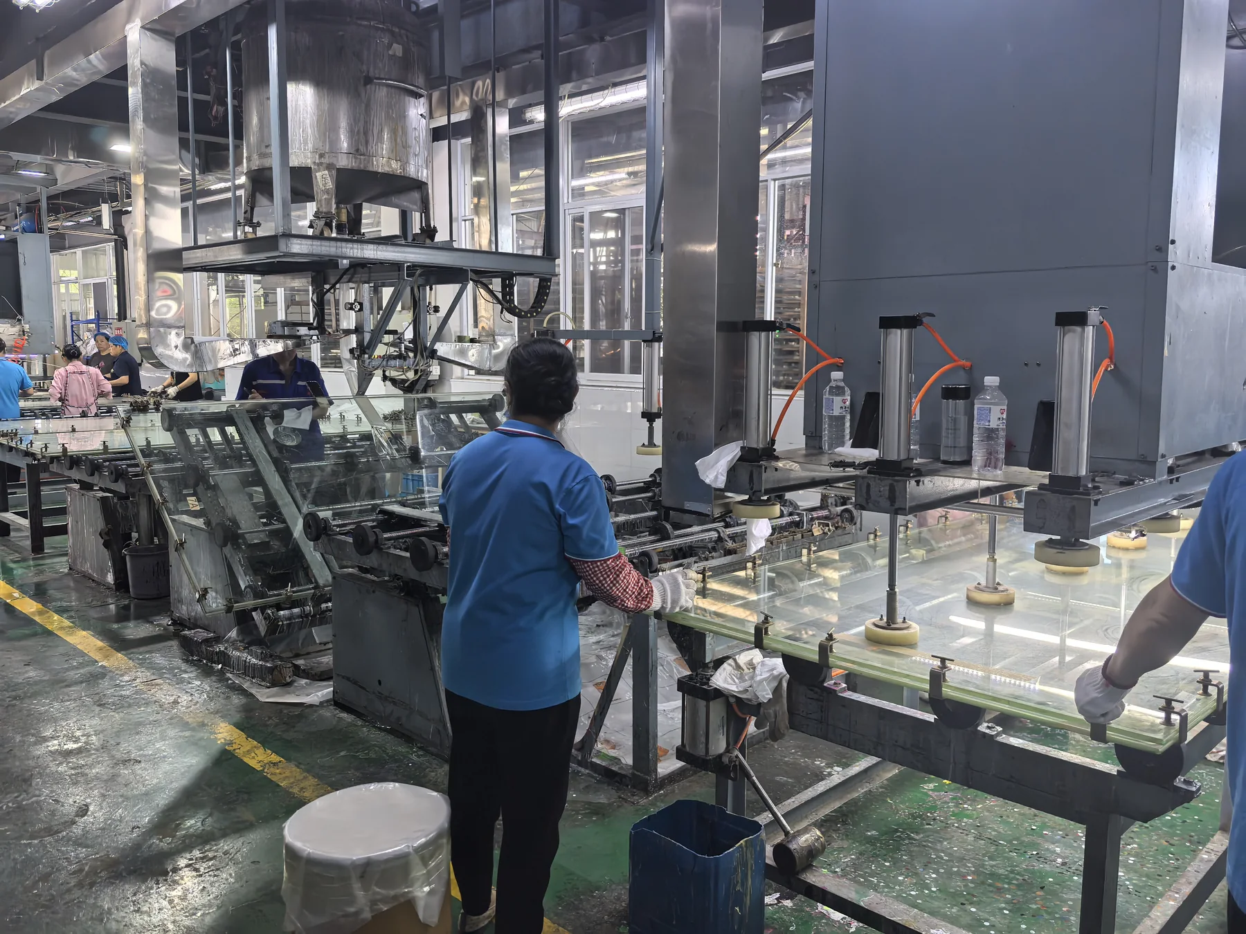 Operators monitoring the cast acrylic sheet production line